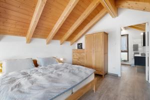 a bedroom with a large bed and wooden ceilings at Charmingly Renovated Stone House in Cesara