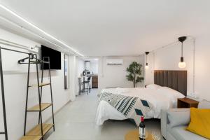 a bedroom with a bed and a living room at Atw Studio in Guanarteme
