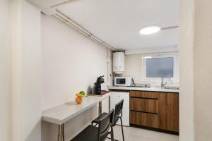 a kitchen with a counter and some chairs in it at Atw Studio in Guanarteme