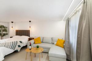 a living room with a couch and a bed at Atw Studio in Guanarteme