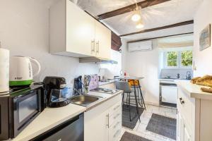a kitchen with white cabinets and a sink at Appartment Schlossmühle in Olsberg in Olsberg