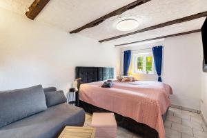 a bedroom with a bed and a couch at Appartment Schlossmühle in Olsberg in Olsberg