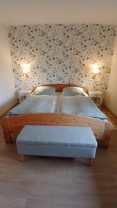 two beds in a bedroom with a wall with hearts at Ferienwohnung 'unter Der Linde' in Neuenkirchen