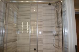 a shower with a glass door in a bathroom at Golden Cross Holiday Park in Hailsham +67 photos