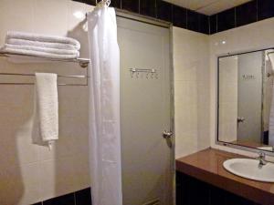 a bathroom with a shower and a sink at Sun Inns Setiawan in Sitiawan +15 photos