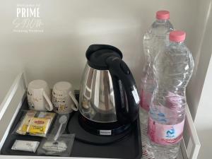 a coffee maker and a bottle of water in a refrigerator at Prime Silom in Bangkok +23 photos