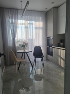 a kitchen with a table and chairs in a room at Апартаменти Центр in Lutsk +3 photos