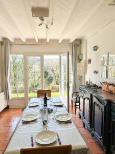 a kitchen with a table with plates and wine glasses at Maison Robinson in Yport