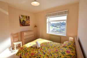 a small bedroom with a bed and a window at 7 Western Hill in Frosterley