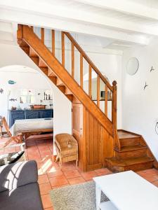 a living room with a staircase and a bedroom at Maison Robinson in Yport +25 photos