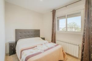 a bedroom with a large bed and a window at El Cauce in Navaluenga +22 photos