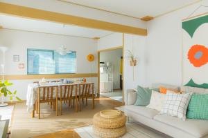 a living room with a table and a couch at kaze no ne in Takachiho