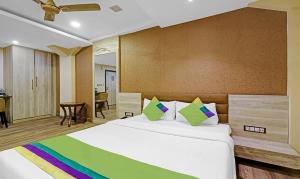 a bedroom with a large bed with a colorful blanket at Hotel Apollo in Guwahati