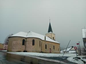 an old church with a steeple with snow on it at ESCALE MORVANDELLE studio 2 personnes in Saint-Brisson +3 photos