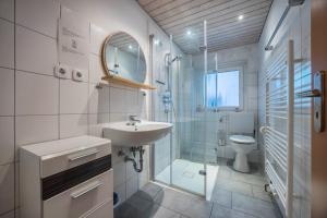 a bathroom with a sink and a shower and a toilet at Gästeapartment Hannover in Hannover +13 photos