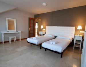 a room with two beds and a fireplace in it at Casa Senda Bardenas in Cabanillas