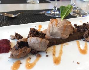 a chocolate dessert with a mint on top on a plate at Casa Senda Bardenas in Cabanillas +6 photos