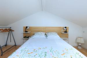 a bedroom with a large bed with a wooden headboard at Loc Ty Home in Soustons