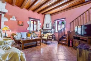 a living room with a couch and a tv at Villa Ira in Agios Leon