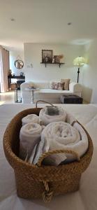 a basket filled with towels on top of a bed at Ari & Alki Garden in Ban Nong Nam Khan