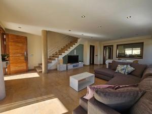 a living room with a couch and a staircase at Antonia in Can Picafort
