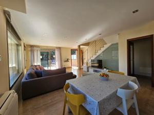 a living room with a table and a couch at Antonia in Can Picafort +26 photos