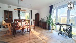 a living room with a table and a dining room at Landhaus Ferien Ostsee in Sterup