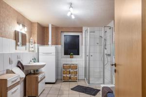 a bathroom with a sink and a shower at Ferienwohnung 2 Hof Schäfer in Waldeck +19 photos