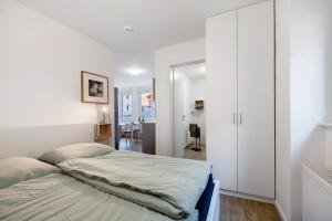 a bedroom with a bed and a white closet at Rieslingglück in Trittenheim