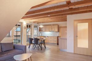 a kitchen and living room with a couch and a table at Ferienwohnung 2 Hof Schäfer in Waldeck