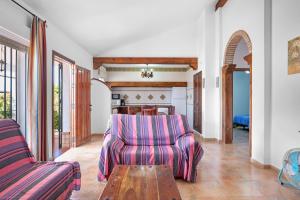 a living room with a couch and a table at Chalet Villa Ariza in Cádiz