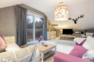 a living room with a couch and a table at Ferienwohnung Solling-Lounge in Holzminden