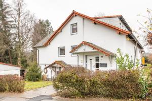 a white house with a red roof at Ferienwohnung Solling-Lounge in Holzminden