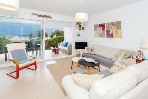 a living room with a white couch and a table at Vista Faváritx in Es Mercadal
