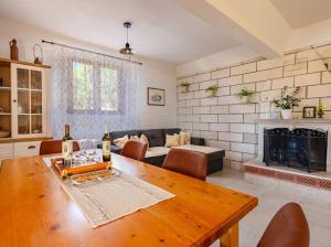 a living room with a table and a fireplace at Stone oasis Marin in Žrnovo