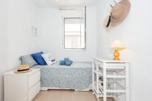 a small bedroom with a bed and a window at Vista Faváritx in Es Mercadal +19 photos