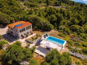 an aerial view of a house with a swimming pool at Stone oasis Marin in Žrnovo