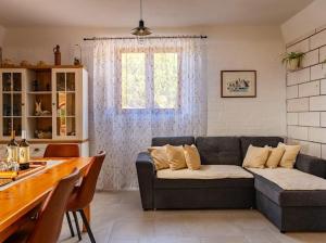 a living room with a couch and a table at Stone oasis Marin in Žrnovo