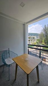 a room with a table and a chair and a window at joyful the Kris406 in Ban Lum Fuang