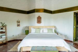 a bedroom with a large bed with white sheets at Ocean View Villa, Pool, BBQ, Jacuzzi, Staff Incl in Cajuiles +54 photos