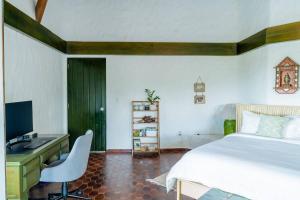 a bedroom with a bed and a desk and a computer at Ocean View Villa, Pool, BBQ, Jacuzzi, Staff Incl in Cajuiles
