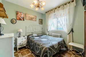 a bedroom with a bed and a dresser and a window at Maitemare in Traspinedo +20 photos