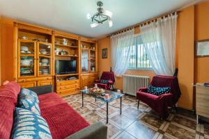 a living room with a couch and chairs and a tv at Maitemare in Traspinedo