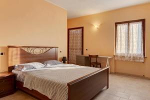 a bedroom with a large bed and a desk at Tenuta Paradiso in Portacomaro +40 photos