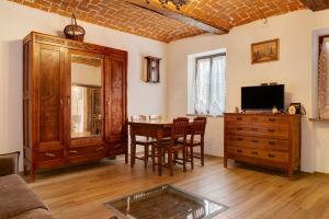 a living room with a table and a tv at Tenuta Paradiso in Portacomaro