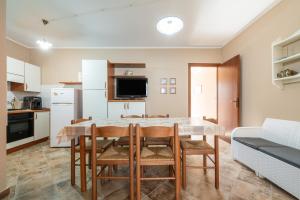 a kitchen and dining room with a table and chairs at Le Sabbie Bianche in Calasetta