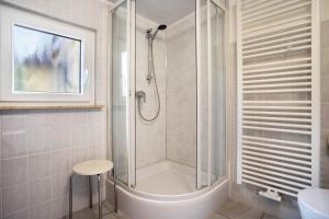 a bathroom with a shower and a sink at Prerow Am Deich - Ferienwohnung 4 in Prerow +15 photos