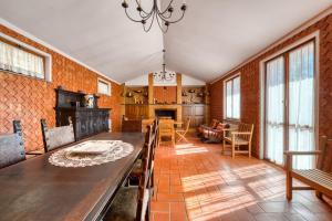 a dining room with a large wooden table and chairs at Villa Marta in Spoleto +24 photos