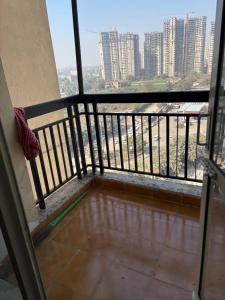 a balcony with a view of a city at Express view homes in Noida