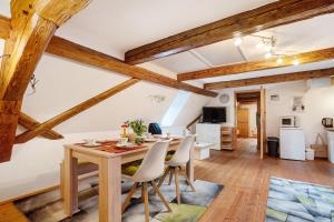 a dining room with a wooden table and chairs at Ferienwohnungen 'am Waldrand' in Bad Gottleuba